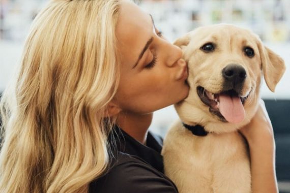 Woman Giving Golden Lab a Kiss