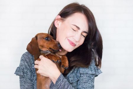 Girl holding a dachshund