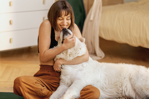 Dog owner hugging dog