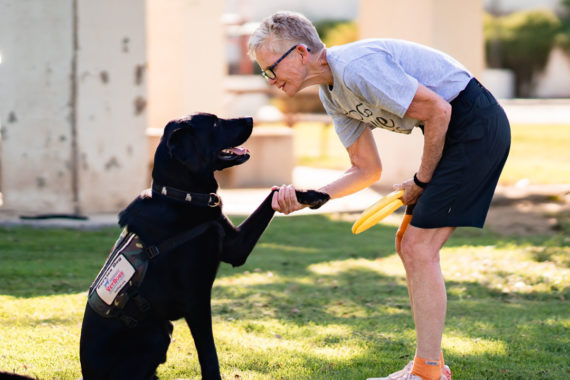 Person holding paw of service dog