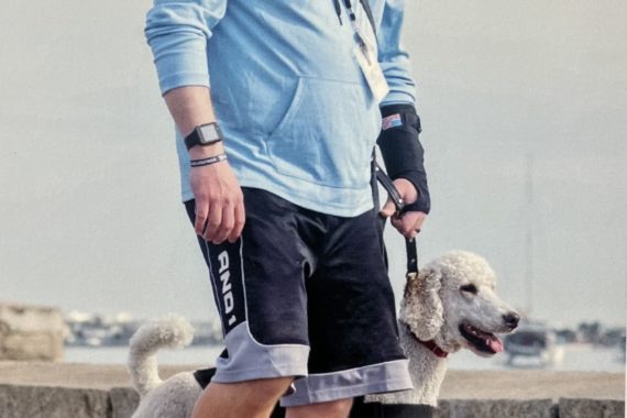 Veteran walking with trained service dog named Trixie