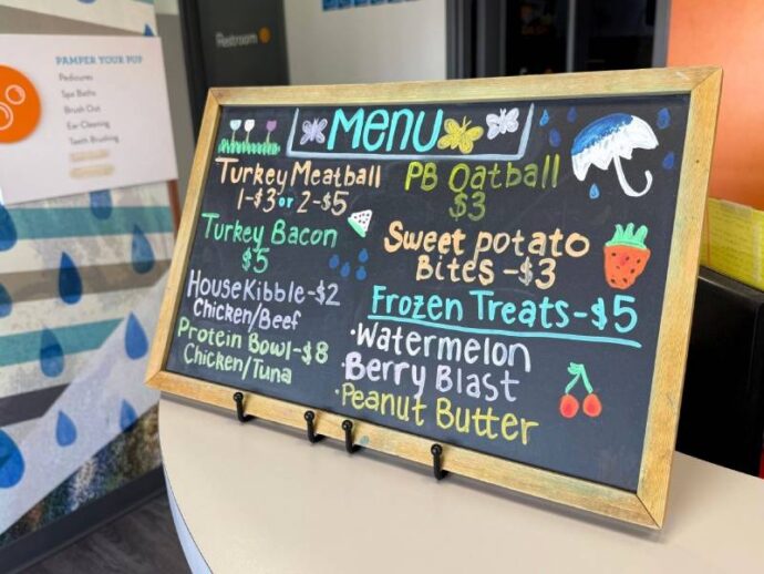 a sign advertising dog treats at daycare