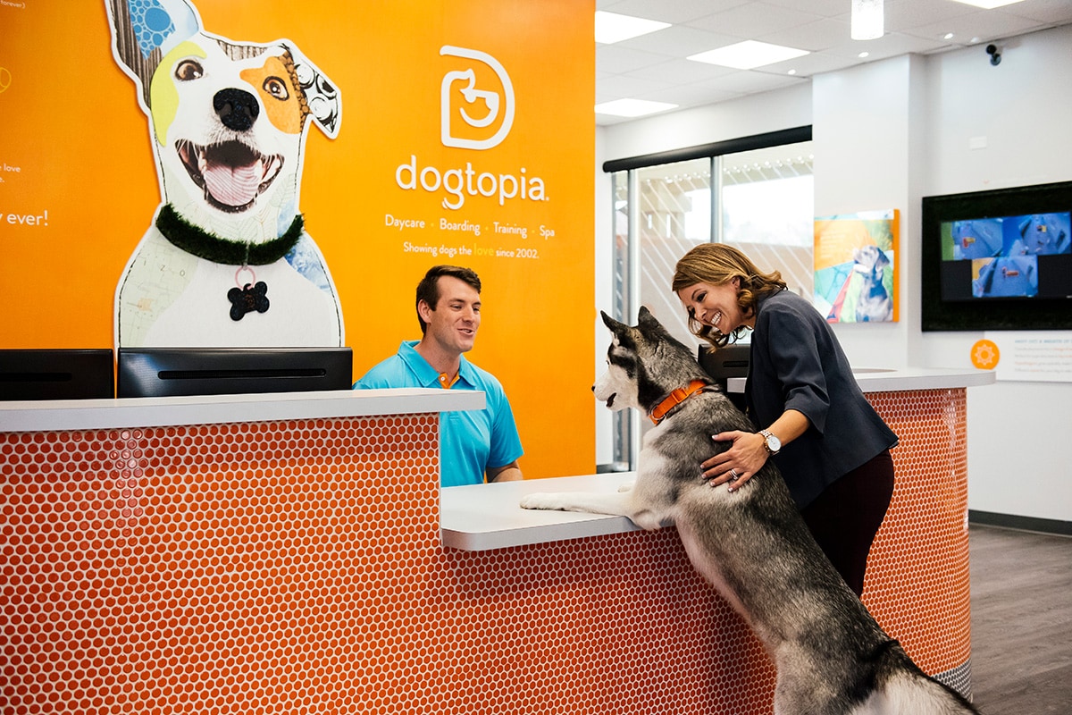 Owner and a dog standing in Dogtopia