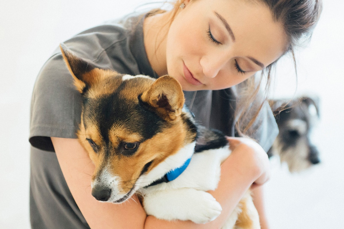 Canine Coach holding a dog in her arms