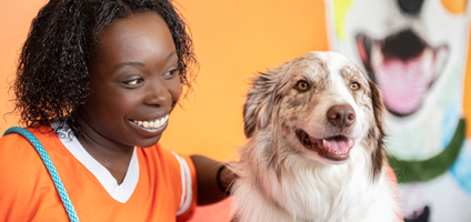 Dogtopia worker petting a dog