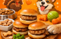 Three turkey sliders stacked on a wooden cutting board with a golden retriever’s paw reaching for one. A bright orange background features a smiling cartoon turkey in a pilgrim hat and a happy cartoon dog surrounded by hearts, paw prints, and dog toys. A bowl of kibble, a heart‑shaped dish of turkey pieces, and parsley garnish complete the playful, pet‑themed scene