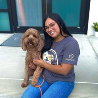 Nicole Peralta, General Manager of Dogtopia of Downtown Orlando, with a dog.