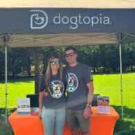 A couple in front of a Dogtopia tent